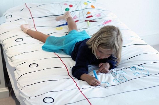 Girl draws on a sheet
