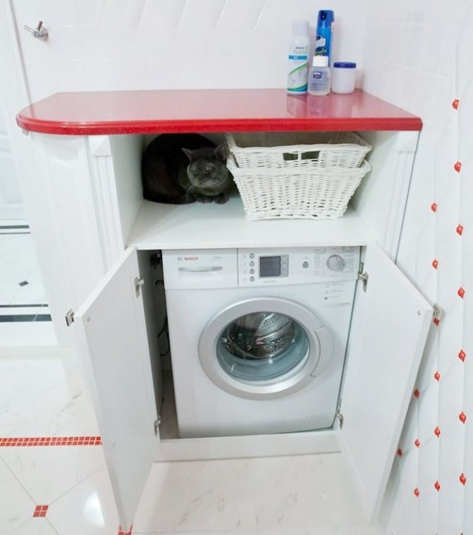 Red shelf above the washing machine in the bathroom
