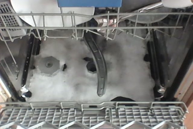Why does my dishwasher leave foam at the bottom or leak out of it?