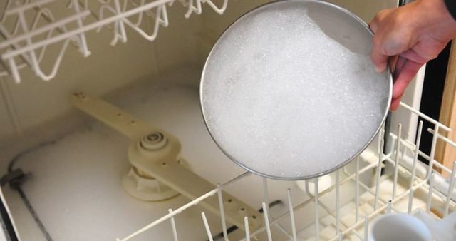 Why does my dishwasher leave foam at the bottom or leak out of it?