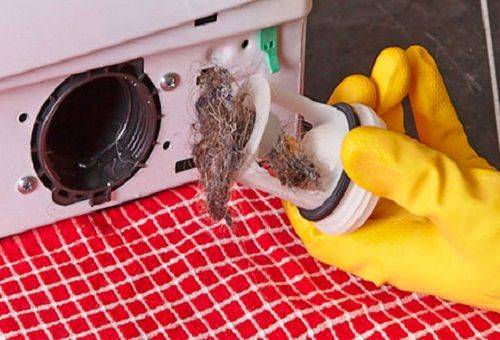 Removing a clogged washing machine drain filter
